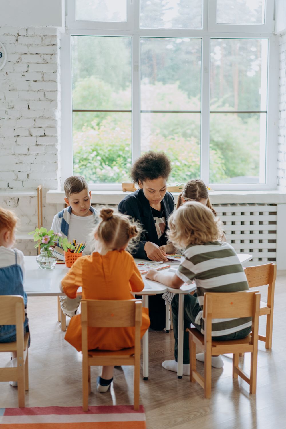 An educator guiding children through a classroom activity