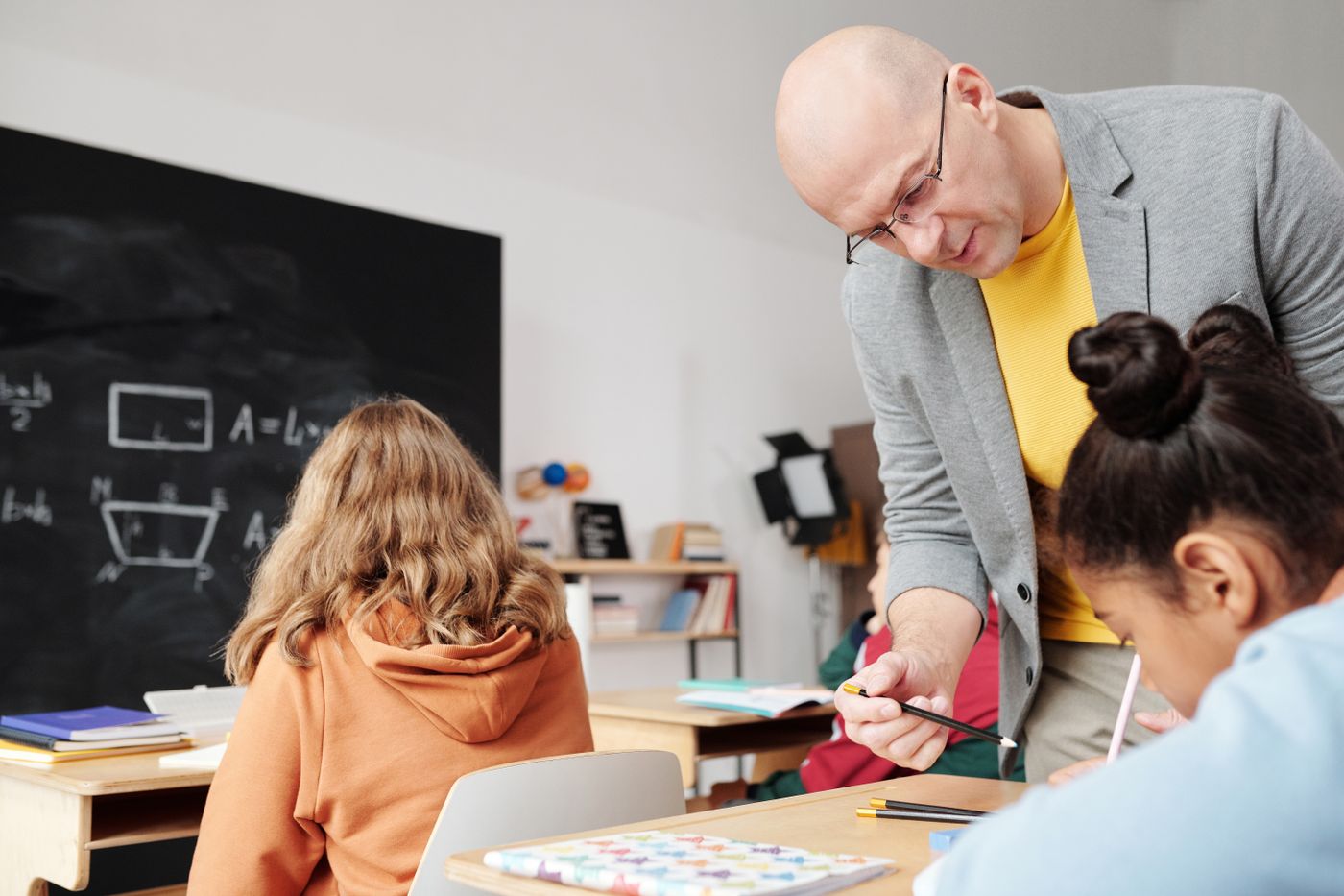 An educator supporting students with classroom work